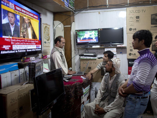 Afghans watch television coverage announcing the killing of Al-Qaeda leader Osama bin Laden at an electronics store 