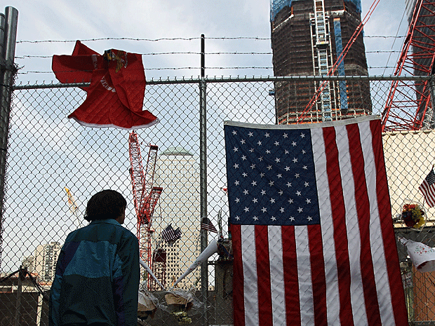 A man views construction at the World Trade Center site as the new One World Trade Center rises behind after the death of accused 9/11 mastermind Osama bin Laden May 3, 2011 