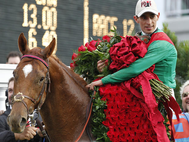 John Velazquez holds the Blanket of Roses after riding Animal Kingdom to victory  
