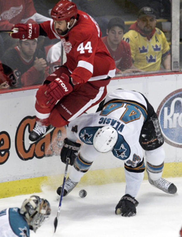 Red Wings' Todd Bertuzzi, top, leaps over Sharks' Marc-Edouard Vlasic 