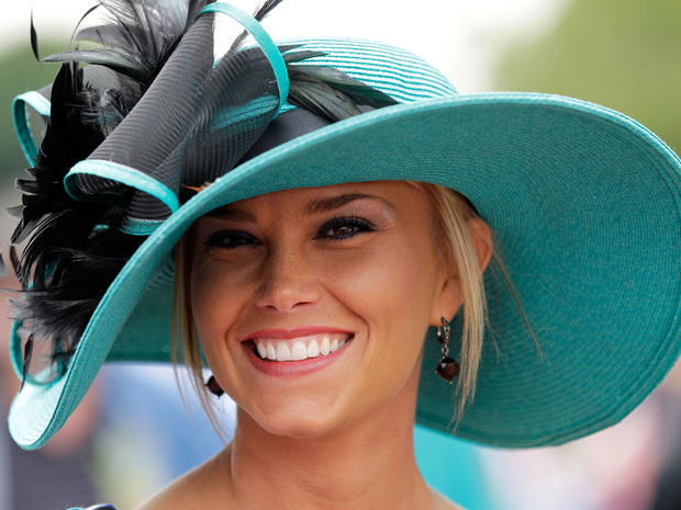 A fan smiles as she poses for a photo wearing her derby hat in the infield during the 137th Kentucky Derby at Churchill Downs on May 7, 2011, in Louisville, Ky.  