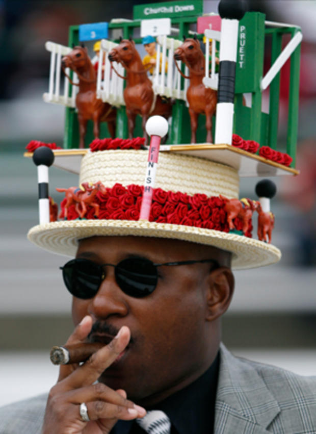 Eric Williams, from Chicago, smokes a cigar before the 137th Kentucky Derby horse race at Churchill Downs, Saturday, May 7, 2011, in Louisville, Ky.  