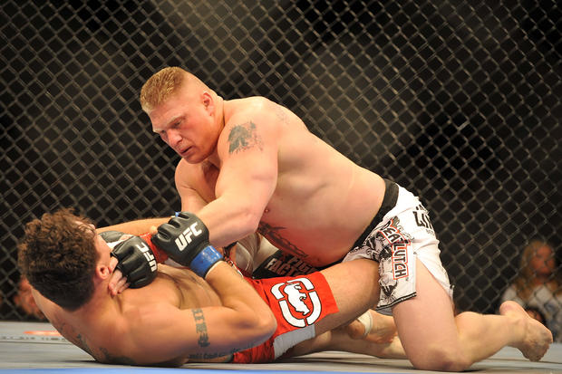 Brock Lesnar holds down Frank Mir during their heavyweight title bout during UFC 100 on July 11, 2009 in Las Vegas, Nevada. 
