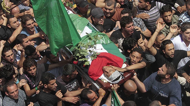 Palestinian mourners carry the body of a Palestinian man who killed when Israeli soldiers opened fire on Sunday at protesters who approached the northen Israeli border with Lebanon, during a funeral procession at Ein el-Hilweh Palestinian refugee camp, in 