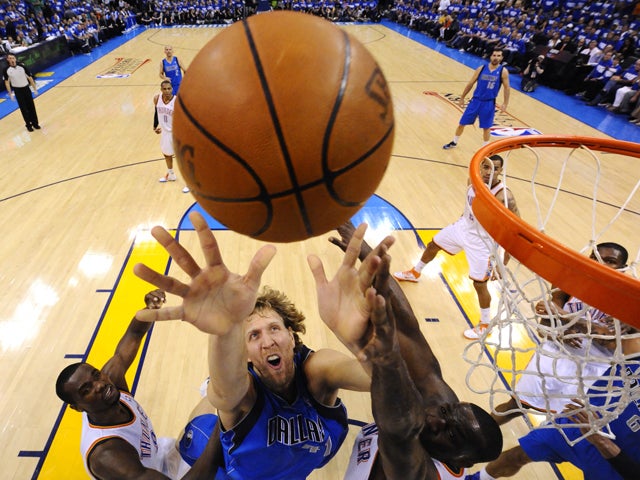 Dallas Mavericks' Dirk Nowitzki fights for the ball 