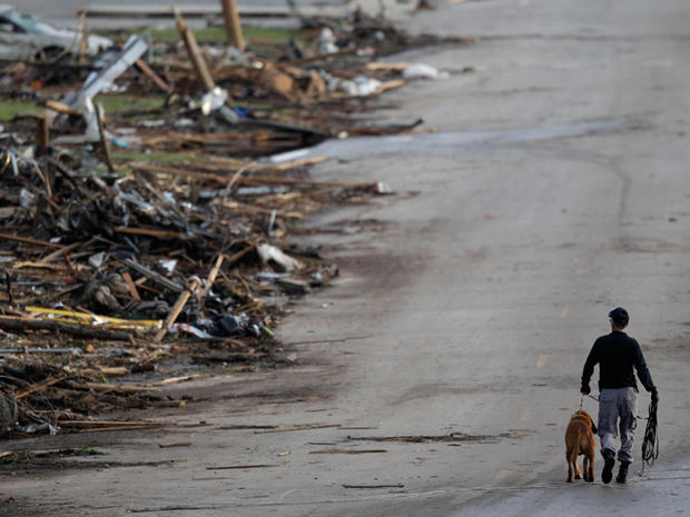 A rescue worker walks past debris at Joplin High School 
