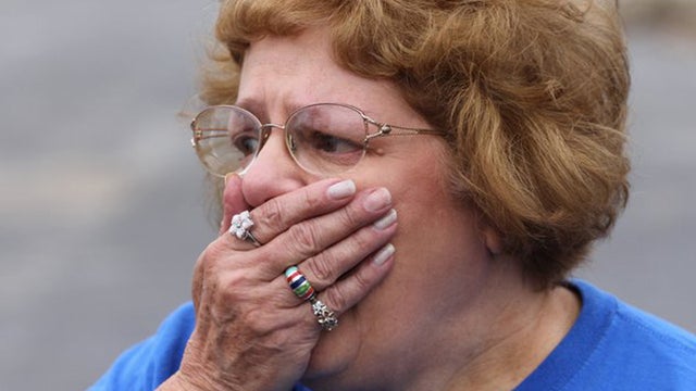 Landlord Sandy Snodgrass reacts after seeing the destroyed apartment complex for the first time since the tornado.  