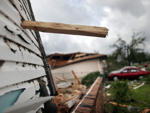 A piece of wood is impaled into a building 