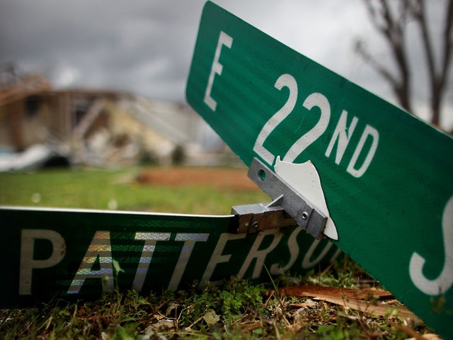 A street sign sits on the ground 