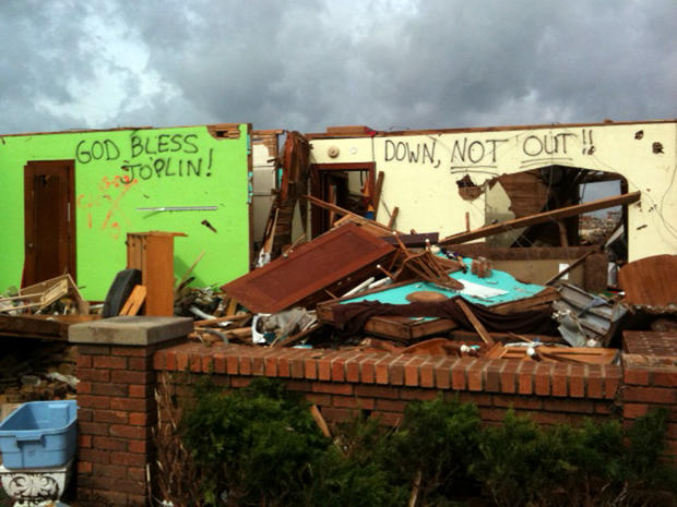 "God bless Joplin," and "Down, not out," is seen spray-painted on damaged buildings in Joplin, Mo. 