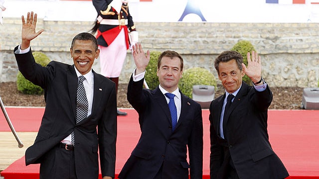 From left, U.S. President Barack Obama, Russian President Dmitry Medvedev and French President Nicolas Sarkozy wave as they arrive for a lunch meeting at the Villa le Cercle during the G8 summit in Deauville, France, May 26, 2011.  