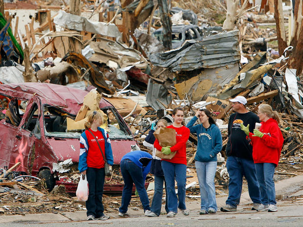 Volunteers stop to look at debris 