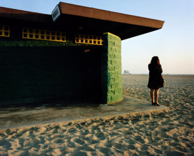 Woman standing outside beach restroom in Santa Monica  
