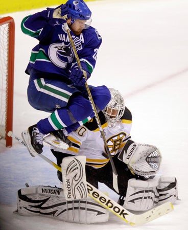 Daniel Sedin leaps on a shot attempt 