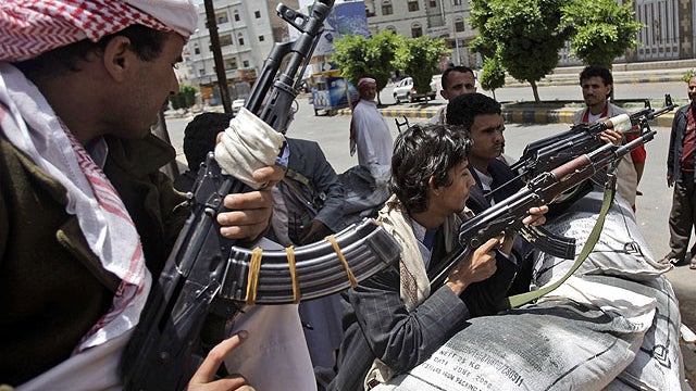 Armed tribesmen, loyal to Sheik Sadeq al-Ahmar, the head of the powerful Hashid tribe, stand guard in a street corner around al-Ahmar's house, during clashes with Yemeni security forces in Sanaa, Yemen, June 6, 2011.  