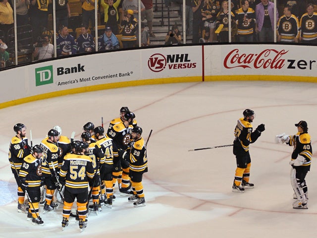 Boston Bruins celebrate after defeating the Vancouver Canucks 