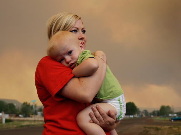 Emily Shupe comforts her 18-month-old son Jax 