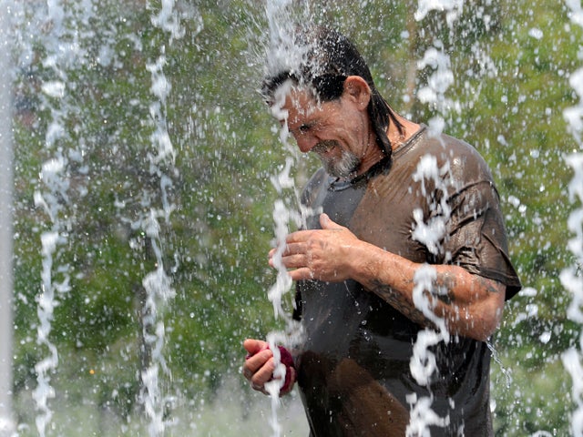 man cools down in a fountain 