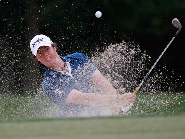 Rory McIlroy chips out of a bunker 