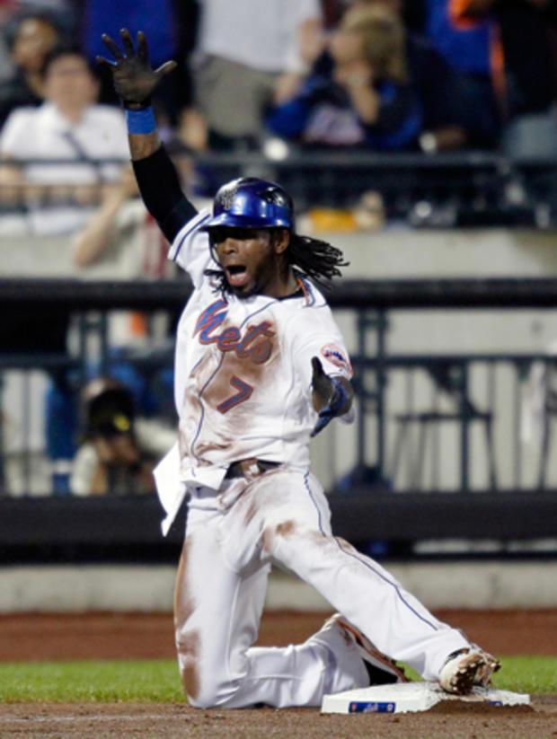 Jose Reyes celebrates after sliding into third base with a triple  