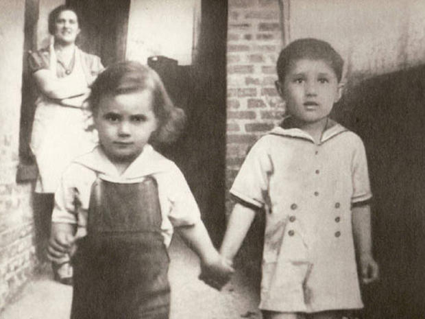 A young John Gotti walks hand-in-hand with brother Peter. 