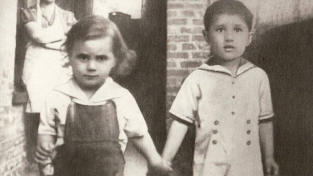 A young John Gotti walks hand-in-hand with brother Peter. 