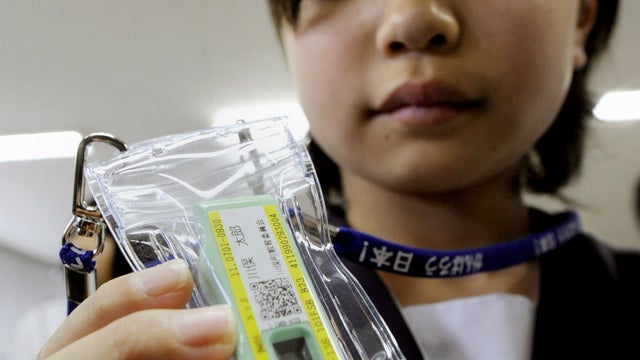 Student holding a radiation meter  