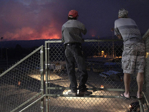 Los Alamos residents Ross Van Lyssel, left, and Steve Bowers watch flames from the Las Conchas fire in Los Alamos, N.M., June 28, 2011.  