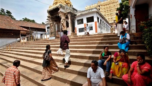 Devotees rest on the steps outside the 16th-century Sree Padmanabhaswamy Temple in Trivandrum, India, Tuesday, July 5, 2011. A vast treasure trove revealed in recent days has instantly turned the Sree Padmanabhaswamy Temple into one of the wealthiest reli 