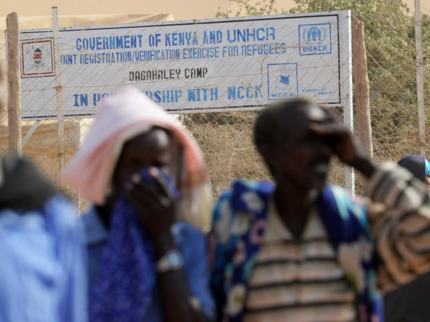 Somali refugees stand outside a registration and food distribution point 