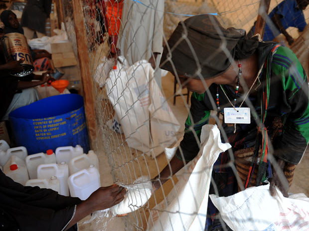 Somali refugee receives aid at a food distribution point at Dadaab refugee camp 