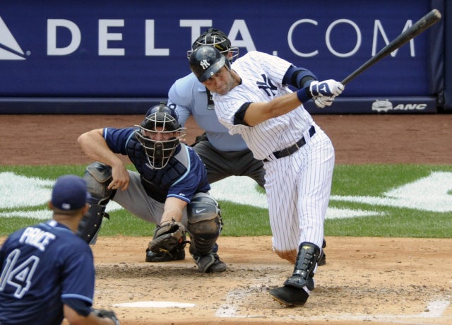 Derek Jeter follows through on a solo home run for his 3,000 