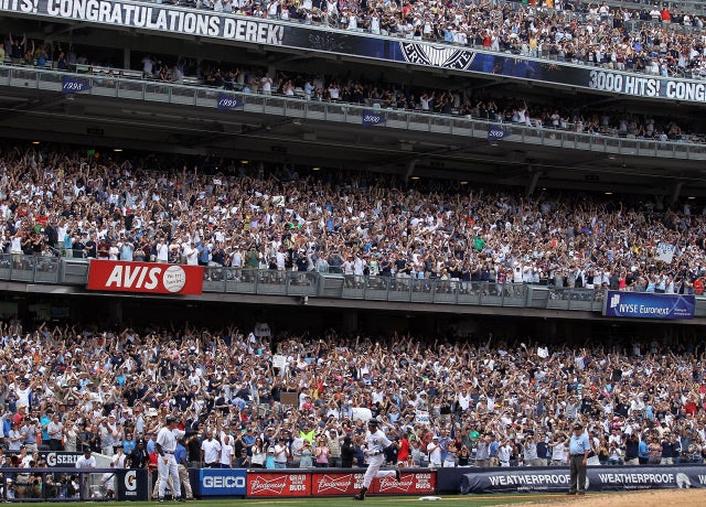 Derek Jeter rounds third base after hitting a solo home run 