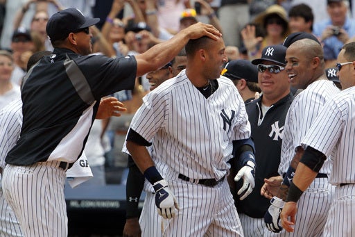 Derek Jeter celebrates at home with teammate Alex Rodriguez  