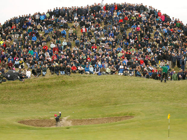 Justin Rose plays a shot from the bunker 