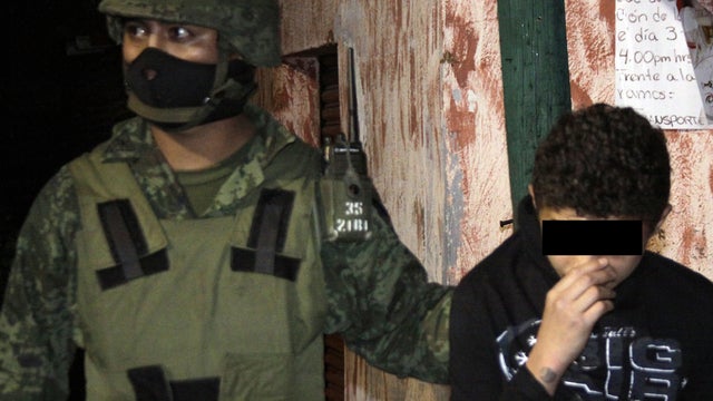 Alleged teen drug cartel hitman is escorted by Mexican police 