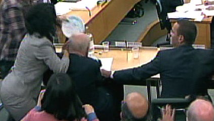 Ruppert Murdoch gets hit in the face with a pie.  