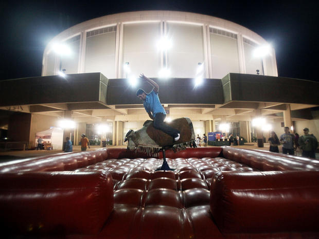 Aaron Erskine rides a mechanical bull at the Biloxi Crawfish Festival on the Gulf Coast April 15, 2011, in Biloxi, Miss. BP says it has made tourism payments of $18 million to Mississippi in an attempt to help draw tourists back to its beaches following 2 