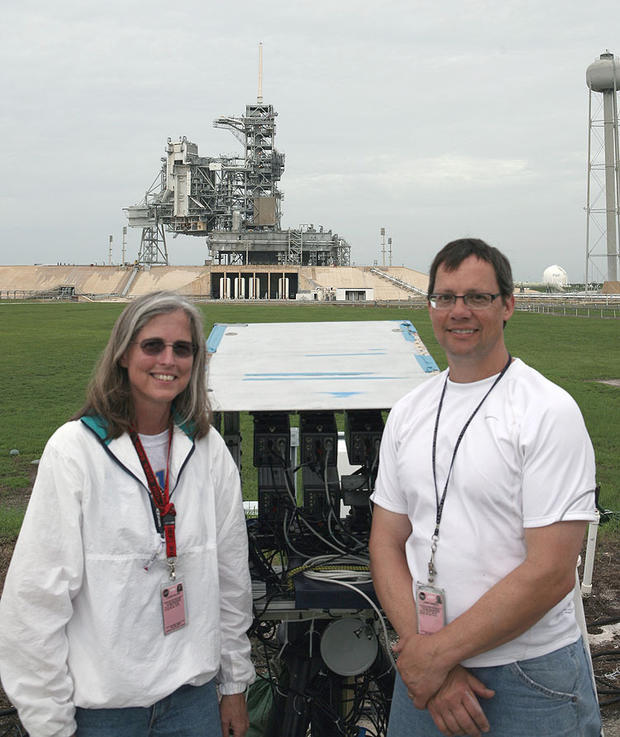 Walker and Heineck with their camera array in front of the launch pad 