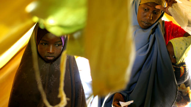 Somali refugees receive soap and an oil container as they check in at a United Nations camp outside Dadaab, Kenya, 60 miles from the Somali border Aug. 5, 2011. The camp, registering more than 1,000 newcomers a day, has been set to provide better accommod 