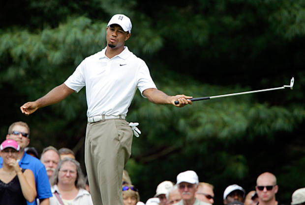 Tiger Woods reacts after missing a birdie putt  