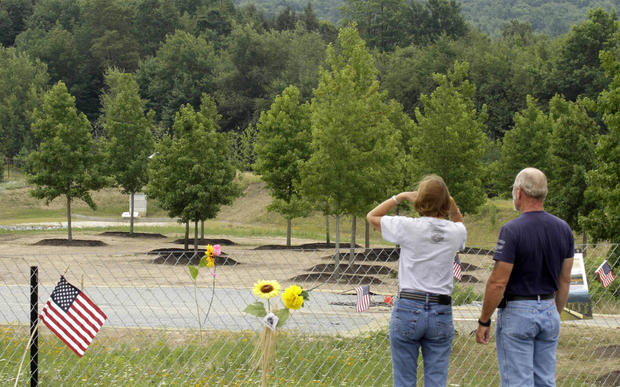 Visitors to the temporary Flight 93 memorial in Shanksville, Pa., look out over a grove of sweet gum trees donated by the organizers of the Sept. 11 Memorial in New York. 