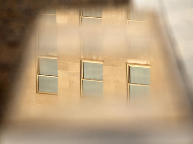 Windows of the Pentagon are reflected on one of the 184 stone benches outside the Pentagon in Arlington, Va. 