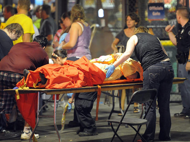 Indianapolis Fire Department personnel and paramedics tend to the victims of a stage collapse before a concert at the Indiana State Fair Grandstands  