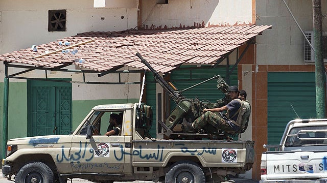 In this Aug. 14, 2011 photo, Libyan rebel fighters are seen in a machine-gun mounted truck in Zawiya, western Libya.  