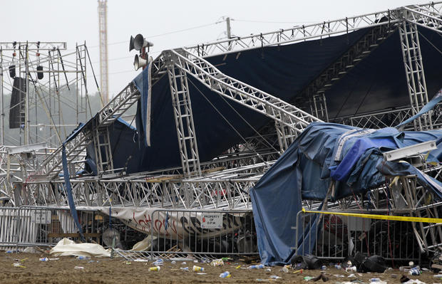 Indiana State Police and authorities survey the collapsed rigging and Sugarland stage on the infield at the Indiana State Fair in Indianapolis, Sunday, Aug. 14, 2011. 