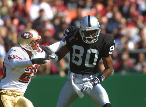 Oakland Raiders wide receiver Jerry Rice pushes of 