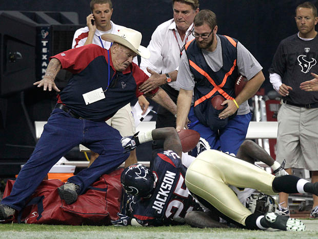 Bum Phillips is knocked to the ground as a play goes out of bounds 