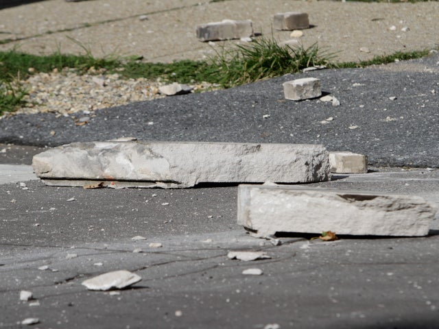 Large pieces of concrete lay in the street in front of the Embassy of Ecuador after the building was damaged in an earthquake.  