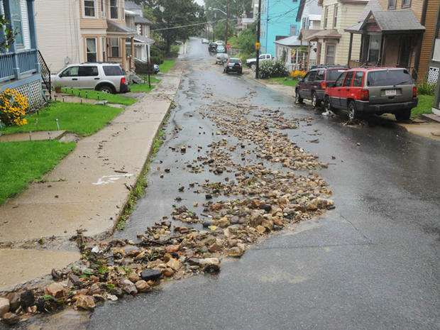 Melon-sized stones clutter the street after flooding 
